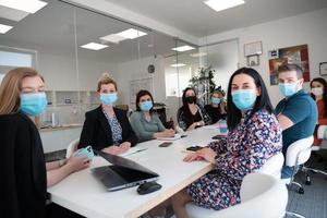 gente de negocios real en reunión con máscara protectora foto
