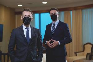 business team wearing crona virus protection face mask photo