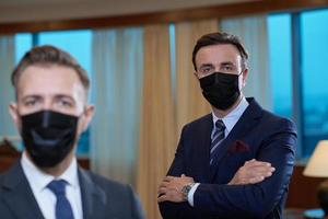 business team wearing crona virus protection face mask photo