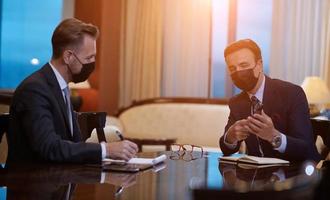 business people wearing crona virus protection face mask on meeting photo