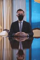 business man wearing protective face mask at luxury office photo