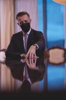 business man wearing protective face mask at luxury office photo