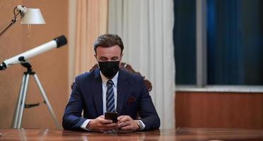 business man wearing protective face mask at office photo