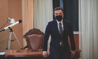 business man wearing protective face mask at office photo