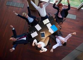 top view of business people group throwing dociments in air photo