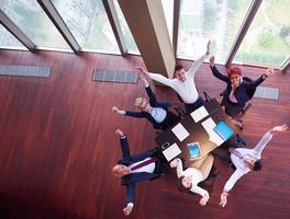 top view of business people group throwing dociments in air photo