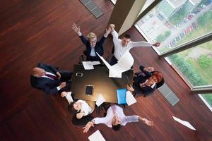 top view of business people group throwing dociments in air photo