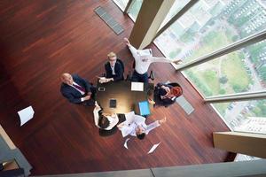 top view of business people group throwing dociments in air photo