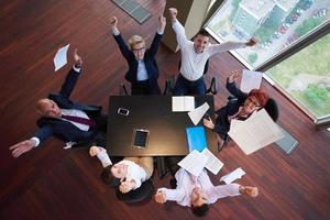 top view of business people group throwing dociments in air photo