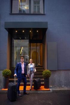 business people couple entering  hotel photo