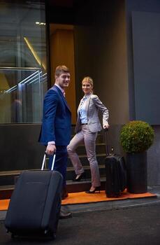 business people couple entering  hotel photo