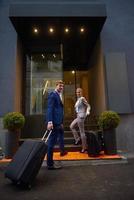 business people couple entering  hotel photo