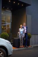 business people couple entering  hotel photo