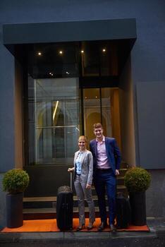 business people couple entering  hotel photo