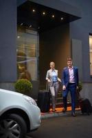 business people couple entering  hotel photo