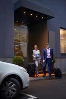 business people couple entering  hotel photo