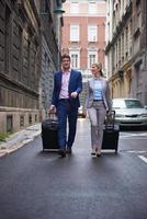 business people couple entering  hotel photo