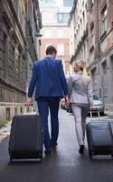 business people couple entering  hotel photo