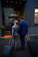 business people couple entering  hotel photo