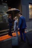 business people couple entering  hotel photo