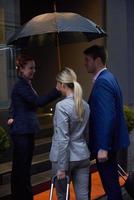 business people couple entering  hotel photo