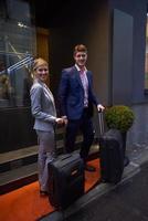 business people couple entering  hotel photo