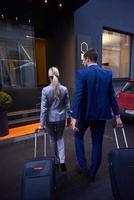 business people couple entering  hotel photo