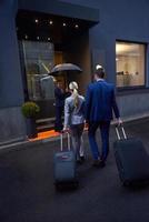 business people couple entering  hotel photo