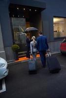 business people couple entering  hotel photo