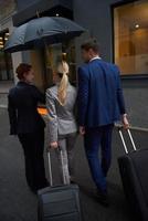 business people couple entering  hotel photo