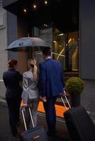 business people couple entering  hotel photo