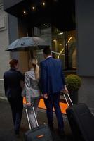 business people couple entering  hotel photo