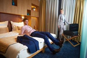 young couple in modern hotel room photo