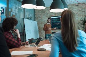 Leader give a business presentation at an office conference meeting, businessman coach mentor explains graph chart on board corporate group workshop training in boardroom. Selective focus photo