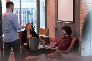 Successful team. Group of young business people working and communicating together in creative office. Selective focus photo