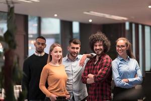 Portrait of successful creative business team looking at camera and smiling. Diverse business people standing together at startup. Selective focus photo