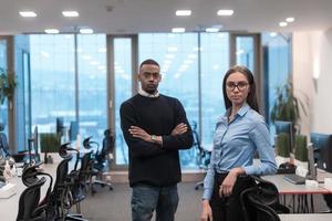 Two happy diverse professional executive business team people woman and African American man looking at camera standing in office lobby hall. Multicultural company managers team portrait. photo