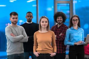Portrait of successful creative business team looking at camera and smiling. Diverse business people standing together at startup. Selective focus photo