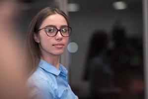 Portrait of freelancer standing in co-working space. Confident businesswoman looking at camera. photo