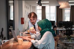 International multicultural business team.A young business man and woman sit in a modern relaxation space and talk about a new business. photo