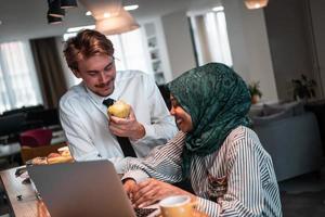 International multicultural business team.A young business man and woman sit in a modern relaxation space and talk about a new business. photo