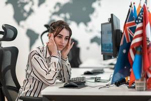 Beautiful Shocked and Annoyed Young Woman Looking her Laptop. Sad Operator Agent Woman Working from Home in a Call Center photo