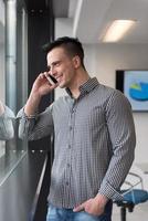 young business man speaking on  smart phone at office photo