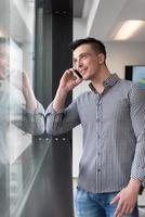 young business man speaking on  smart phone at office photo