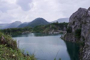 The limestone mountains after the concession explosion during the rainy season form a large and beautiful pond. photo