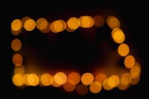 Take the light out of focus to create an oval, amber-colored bokeh in the darkness. photo