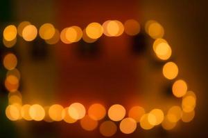 Take the light out of focus to create an oval, amber-colored bokeh in the darkness. photo