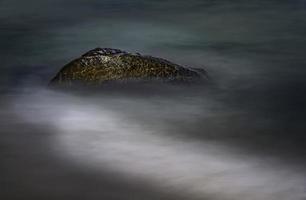 Alone stone on the beach photo