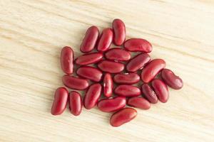 red kidney bean are placed on the wood background at the center of the image, top-down,top-view,flat lay. photo