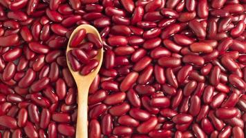 Close-up photo of several red kidney beans  and wooden spoon,top view,flay lay,top-down.